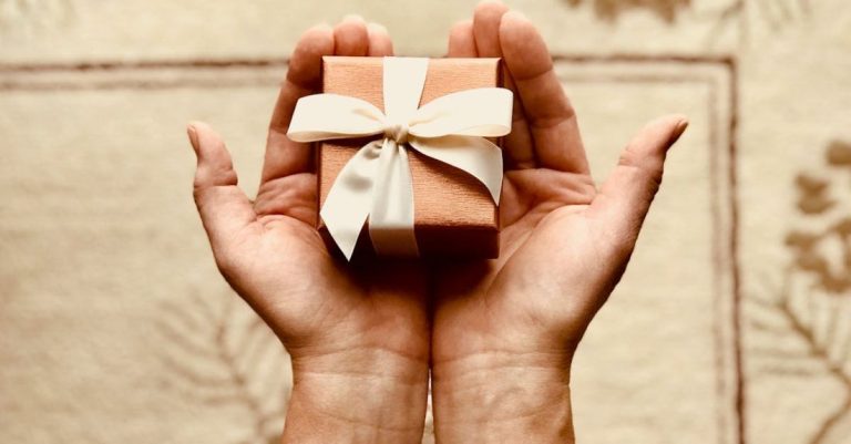 Package - Person's Holds Brown Gift Box