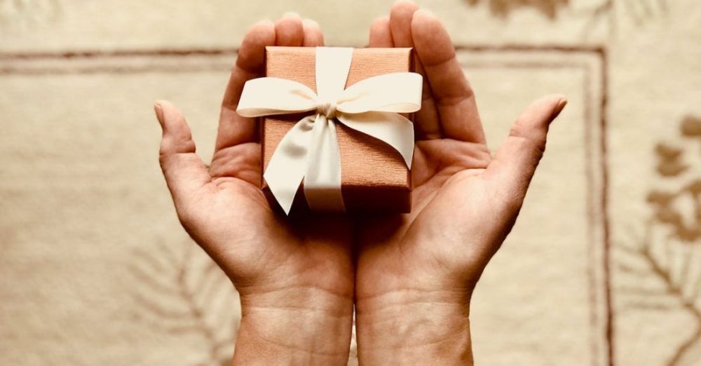 Package - Person's Holds Brown Gift Box