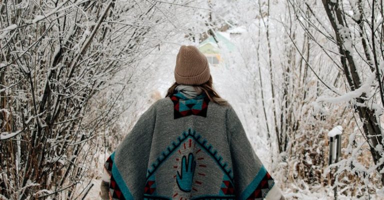 Walks - Girl in a poncho walk in winter forest